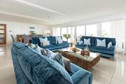 The open plan living/dining room has patio doors that open up the apartment to the wonderful view of the beach and coastline.