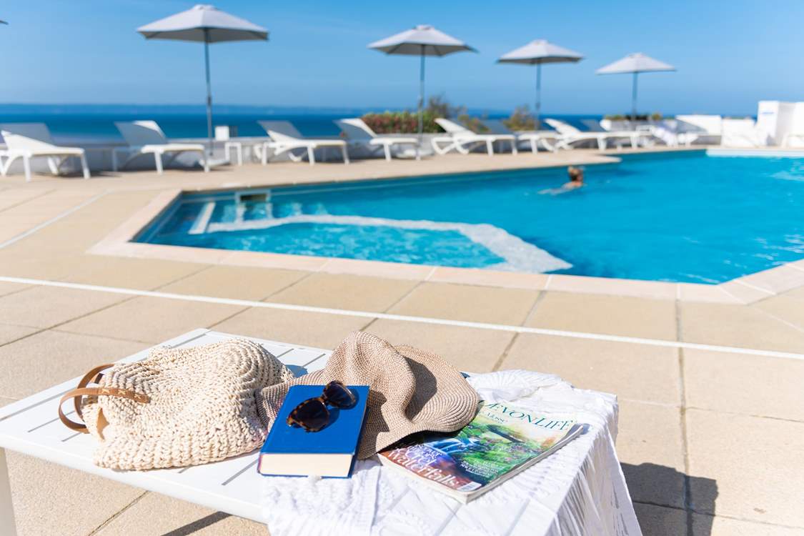 The hotel pool offers the perfect spot to indulge in a book.