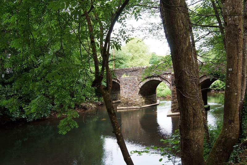 The approach to Leat Mill Cottage is over the small bridge and down beside the river.