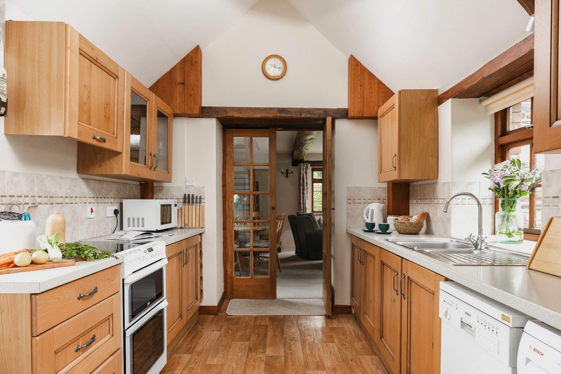 The kitchen leads into the sitting-room.