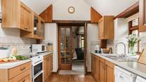 The kitchen leads into the sitting-room.