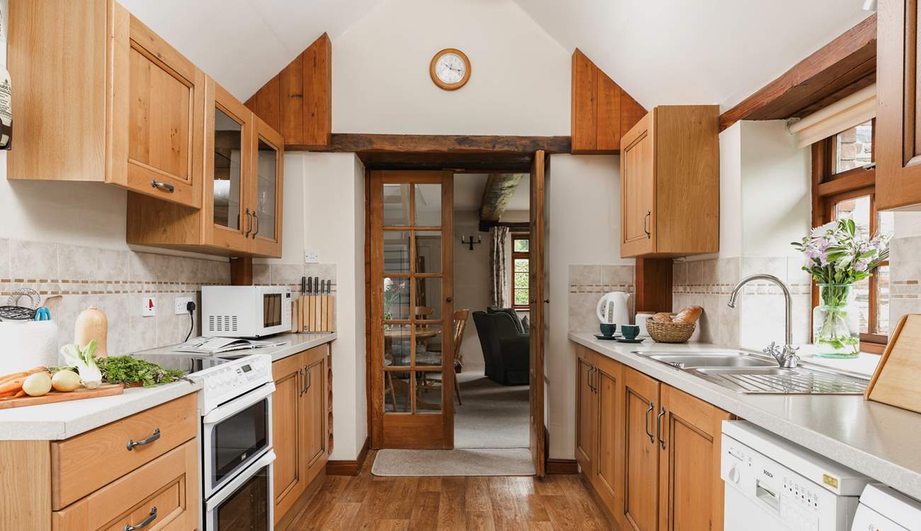 The kitchen leads into the sitting-room.