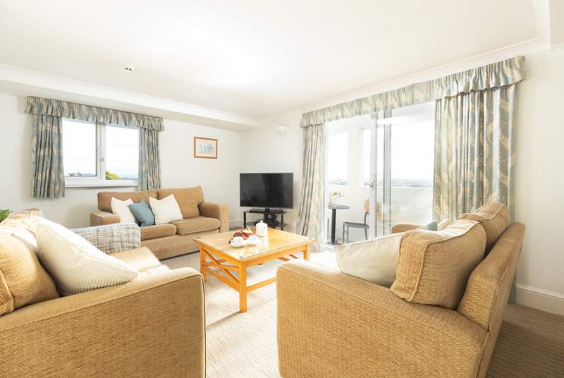 The light and airy sitting-room has a balcony - the perfect spot to enjoy your morning coffee.