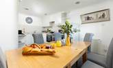 The kitchen and dining area is a great place to come together to plan your day's adventures. - Thumbnail Image