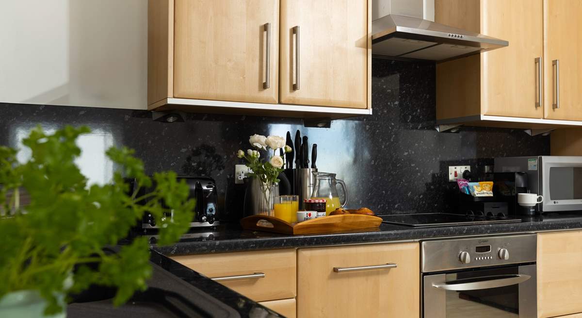 A fully equipped kitchen awaits along with a Nespresso coffee machine. 