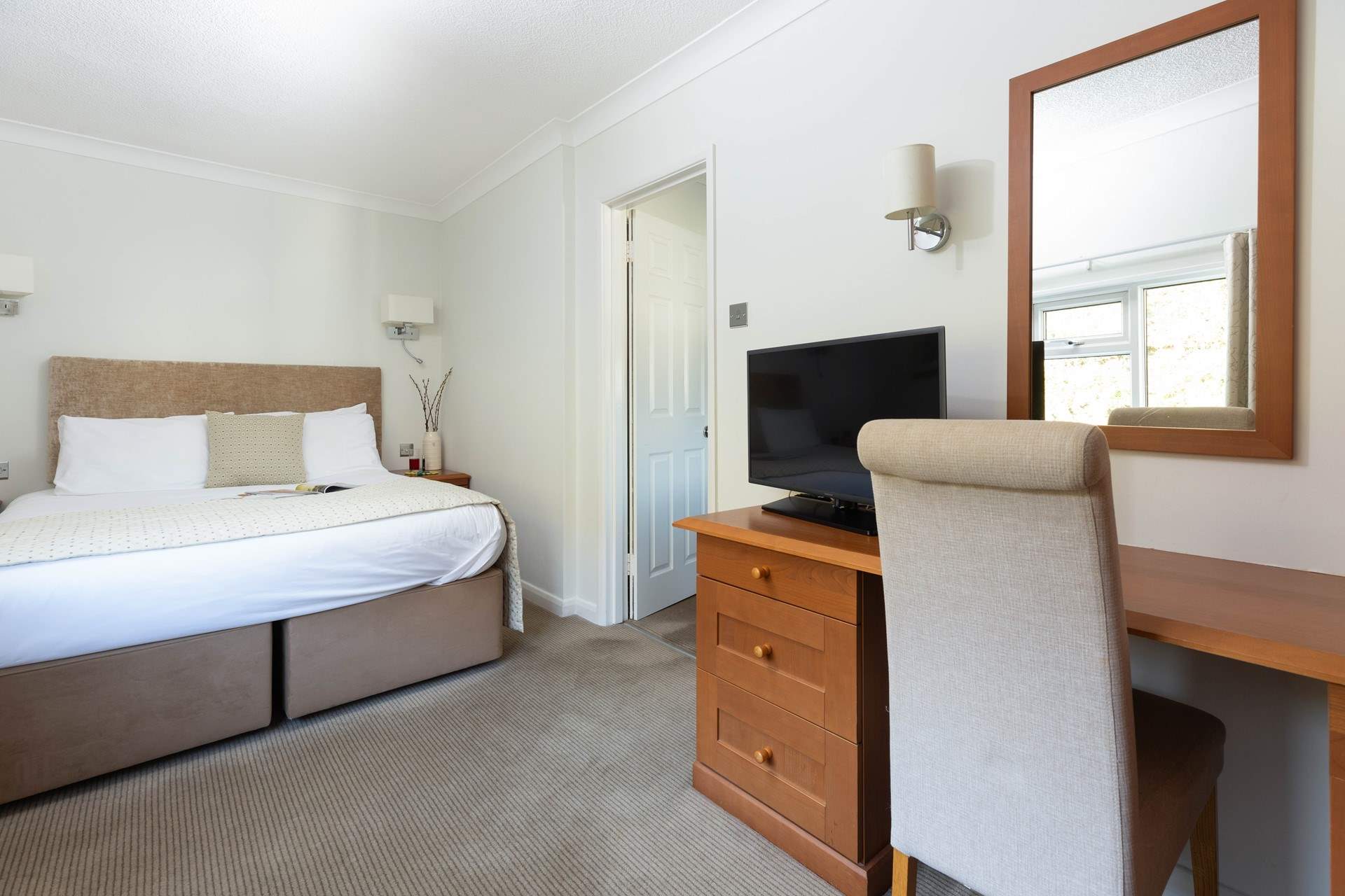 This spacious bedroom offers a comfy bed and a TV should you need to retreat. 