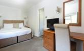 This spacious bedroom offers a comfy bed and a TV should you need to retreat.  - Thumbnail Image
