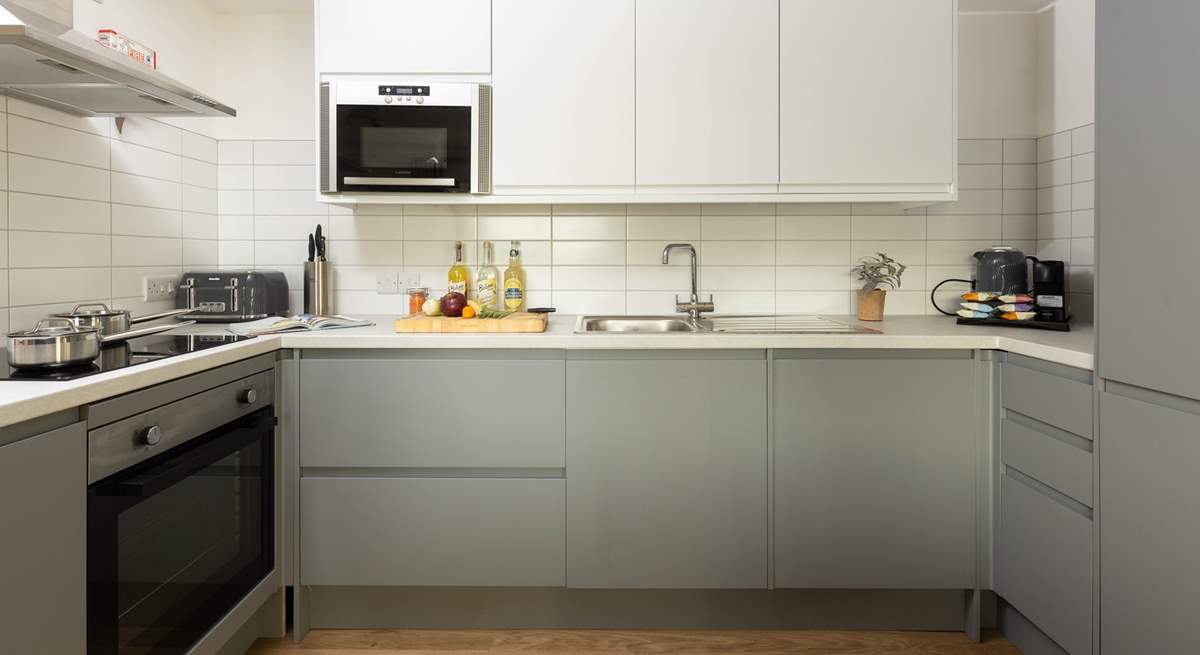 The stylish kitchen is fully equipped and ready for your arrival.