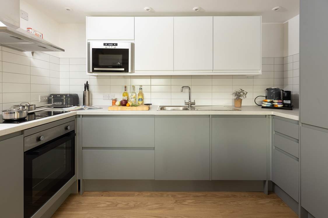 The stylish kitchen is fully equipped and ready for your arrival.