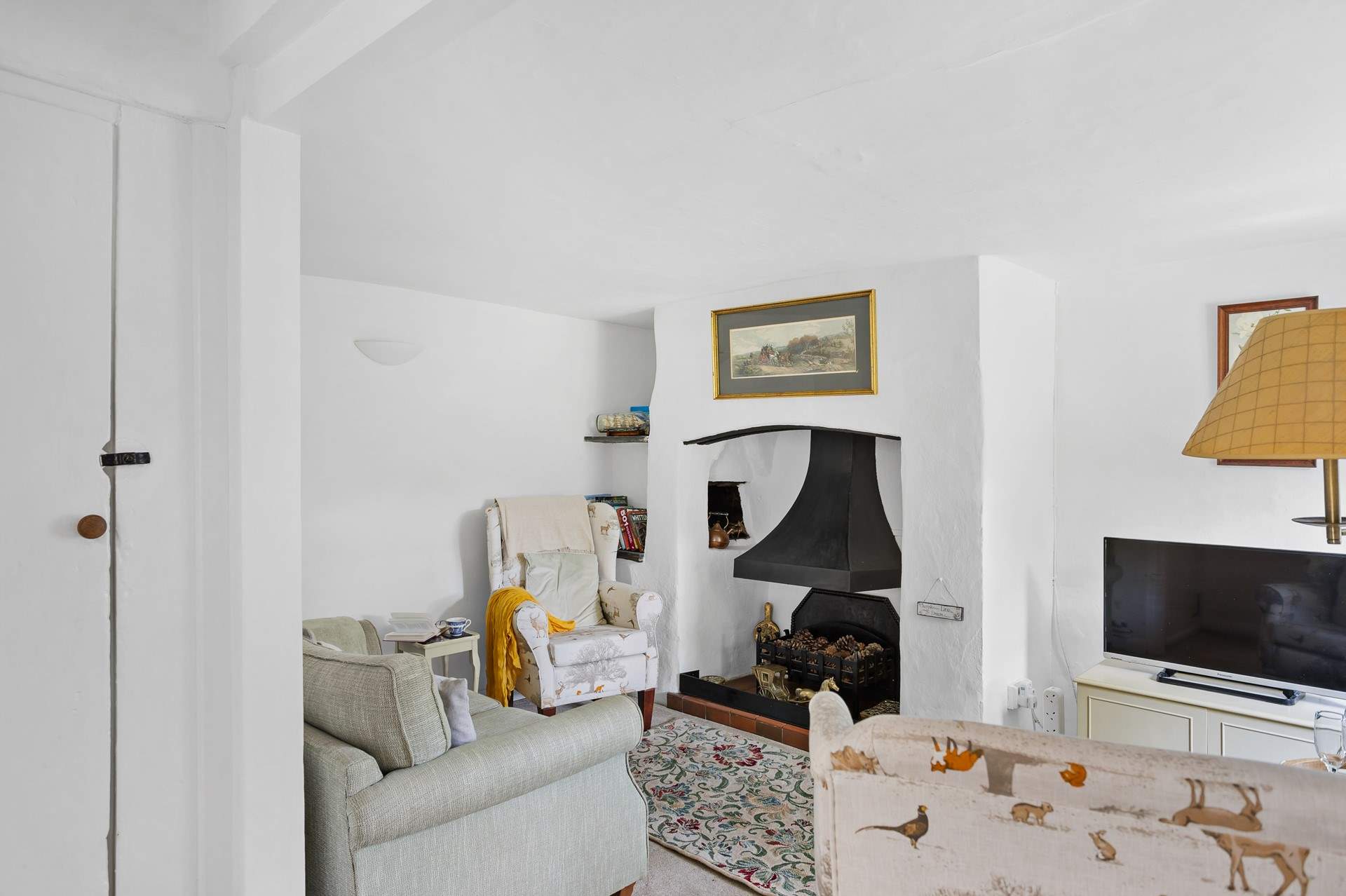 The cute sitting-room has an ornamental fireplace and Smart TV, perfect for a film night after enjoying a coastal walk.