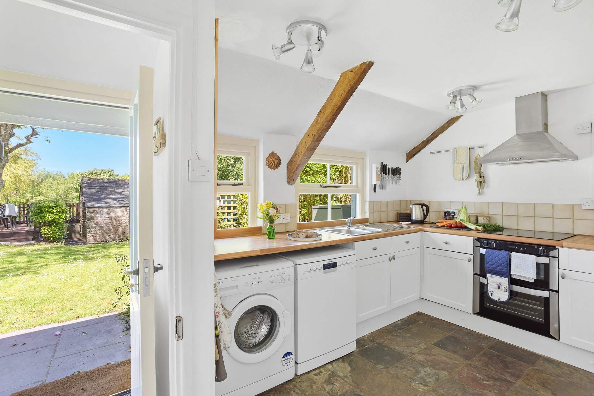 Enter through the back of the house into the fully equipped kitchen.