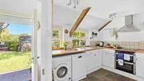Enter through the back of the house into the fully equipped kitchen.