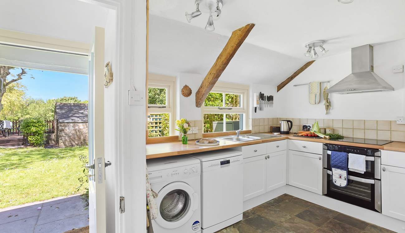 Enter through the back of the house into the fully equipped kitchen.