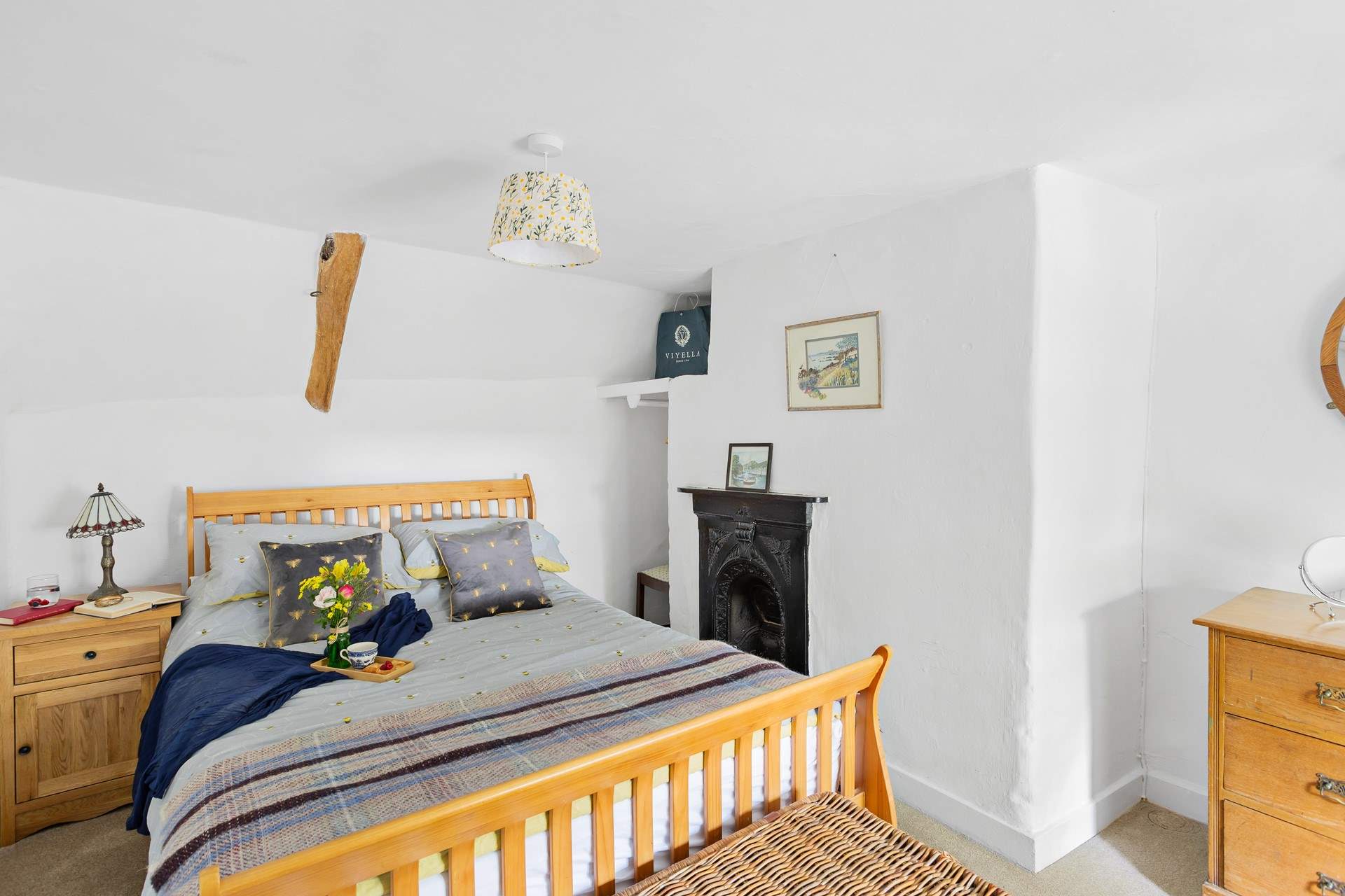 The cottage bedroom is both charming and welcoming. 