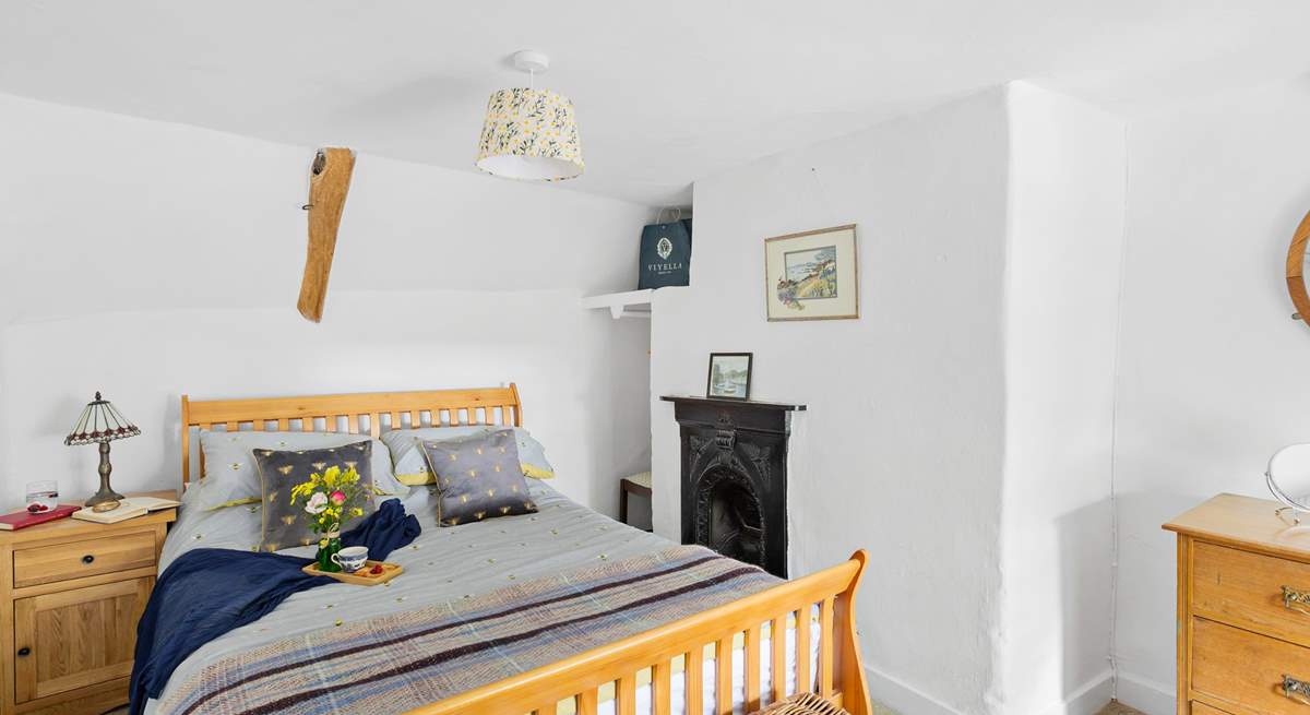 The cottage bedroom is both charming and welcoming. 