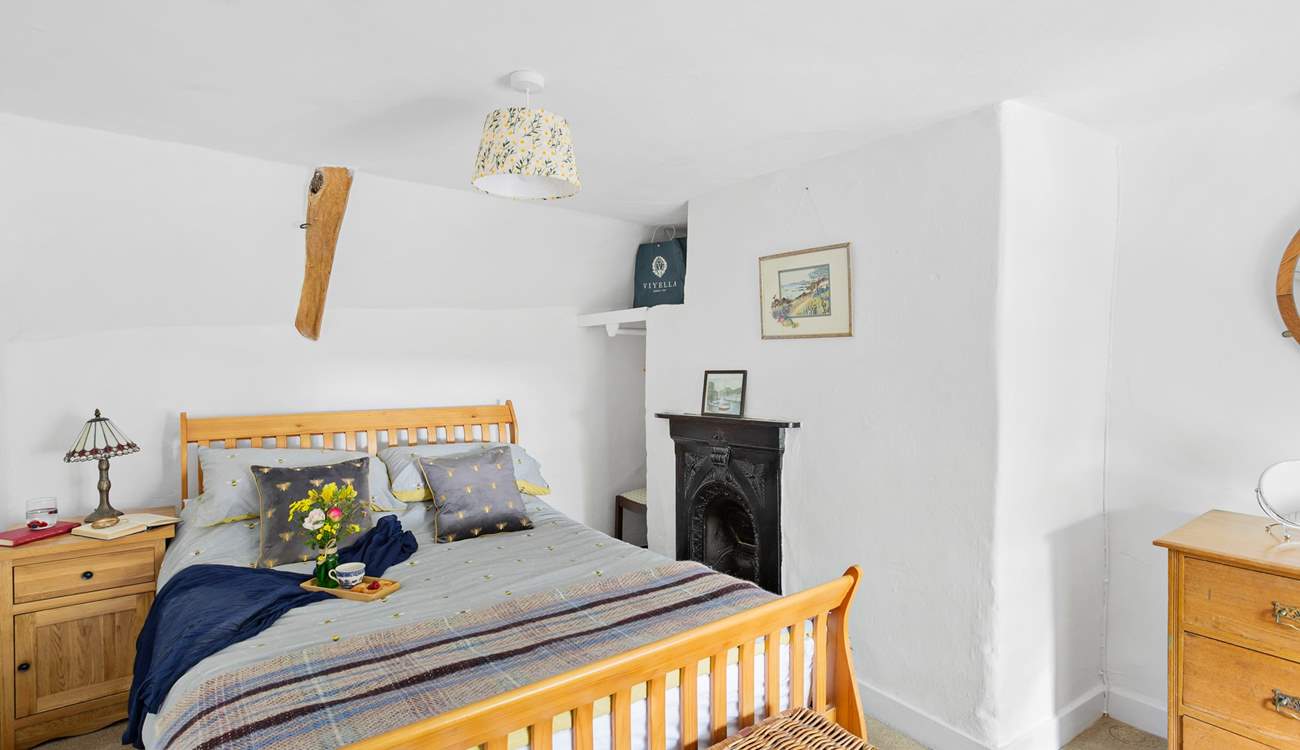 The cottage bedroom is both charming and welcoming. 