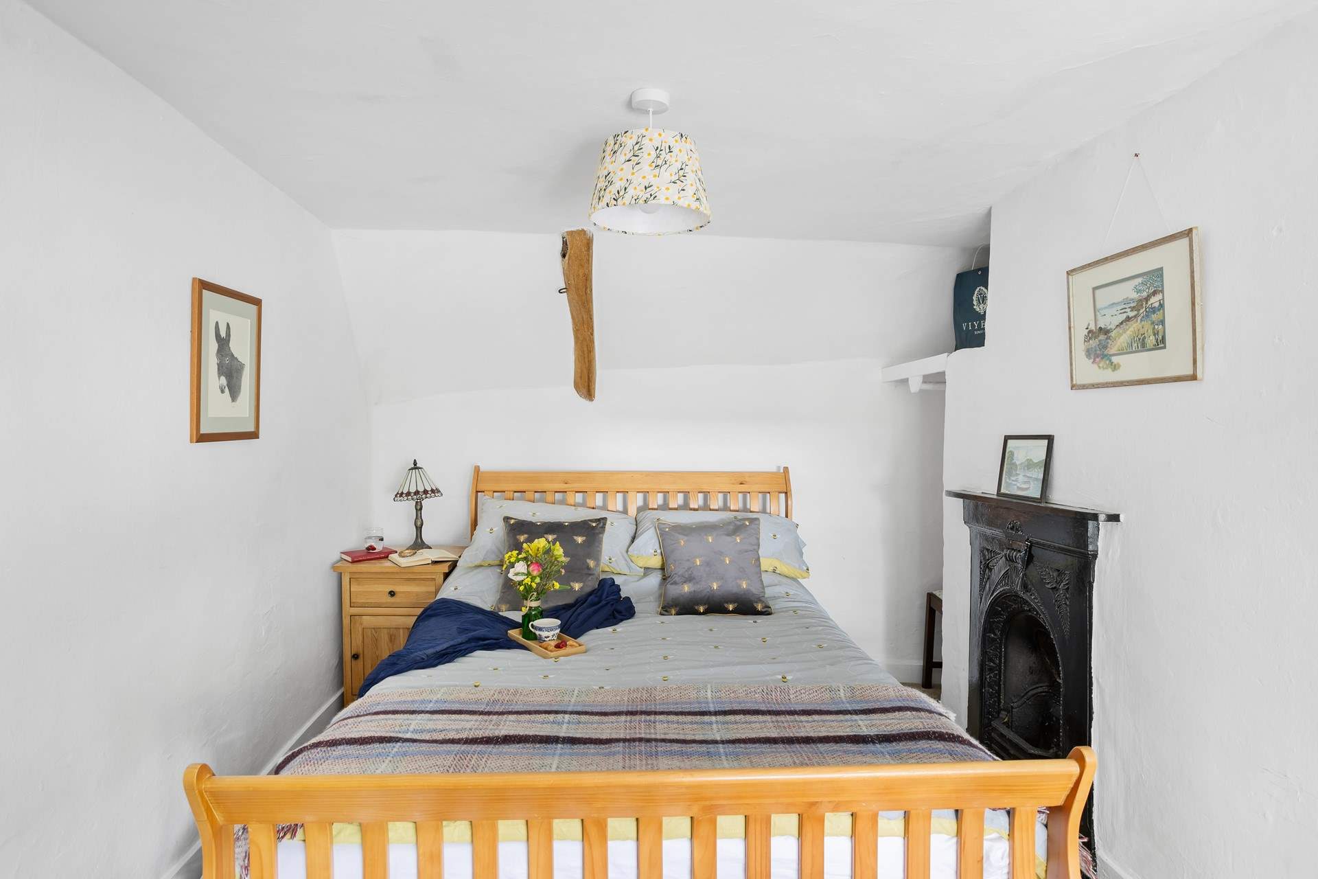 The main bedroom is a charm with views out to the front of the cottage.