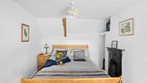 The main bedroom is a charm with views out to the front of the cottage.