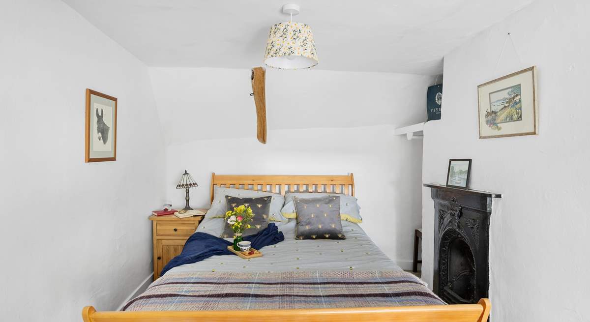 The main bedroom is a charm with views out to the front of the cottage.