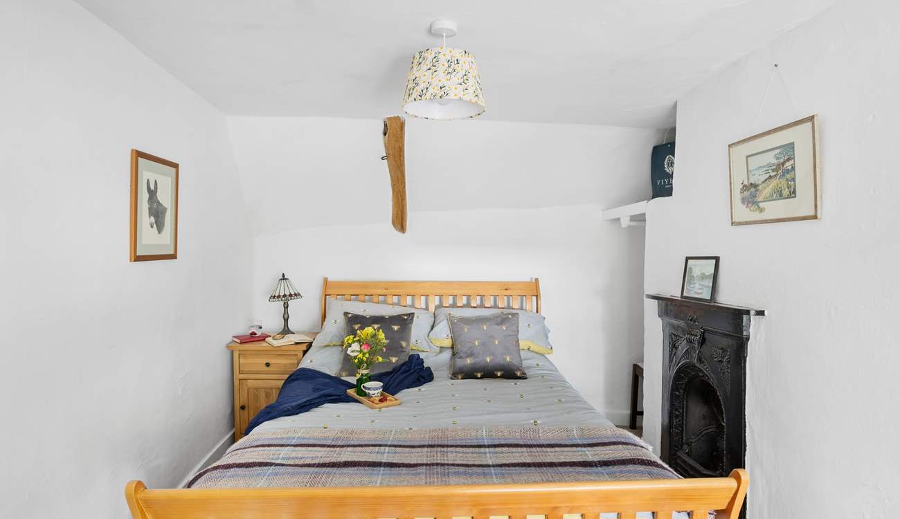 The main bedroom is a charm with views out to the front of the cottage.