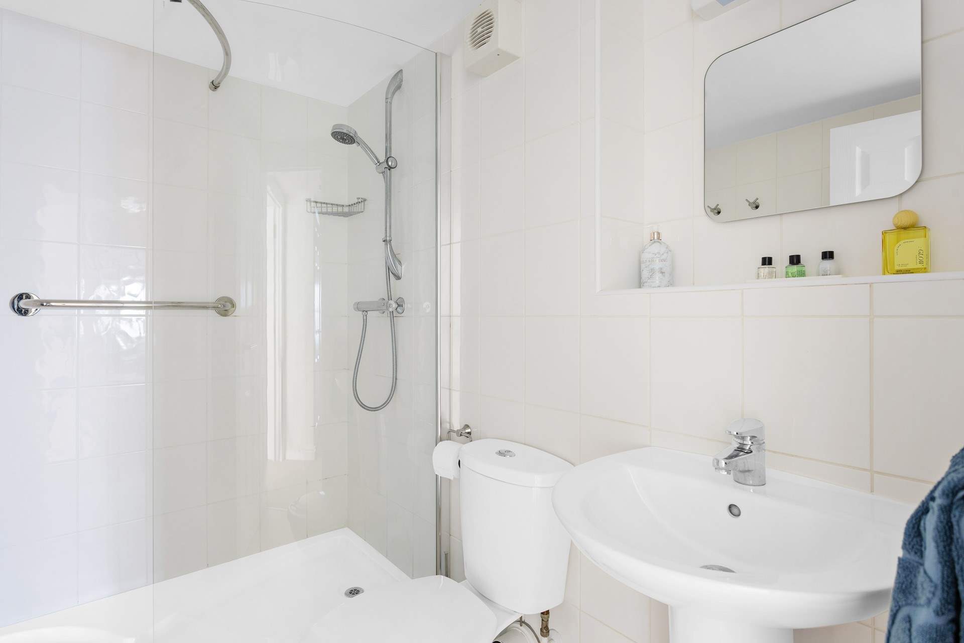 The modern shower-room sits opposite the bedroom door.