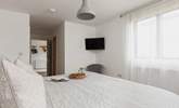 Bedroom one sits off the entrance hall and benefits from an en suite shower-room and Smart TV. - Thumbnail Image