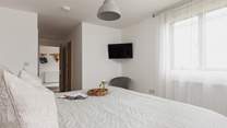 Bedroom one sits off the entrance hall and benefits from an en suite shower-room and Smart TV.