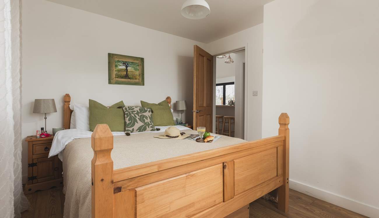 This bedroom is dual aspect with a king-size bed and TV.