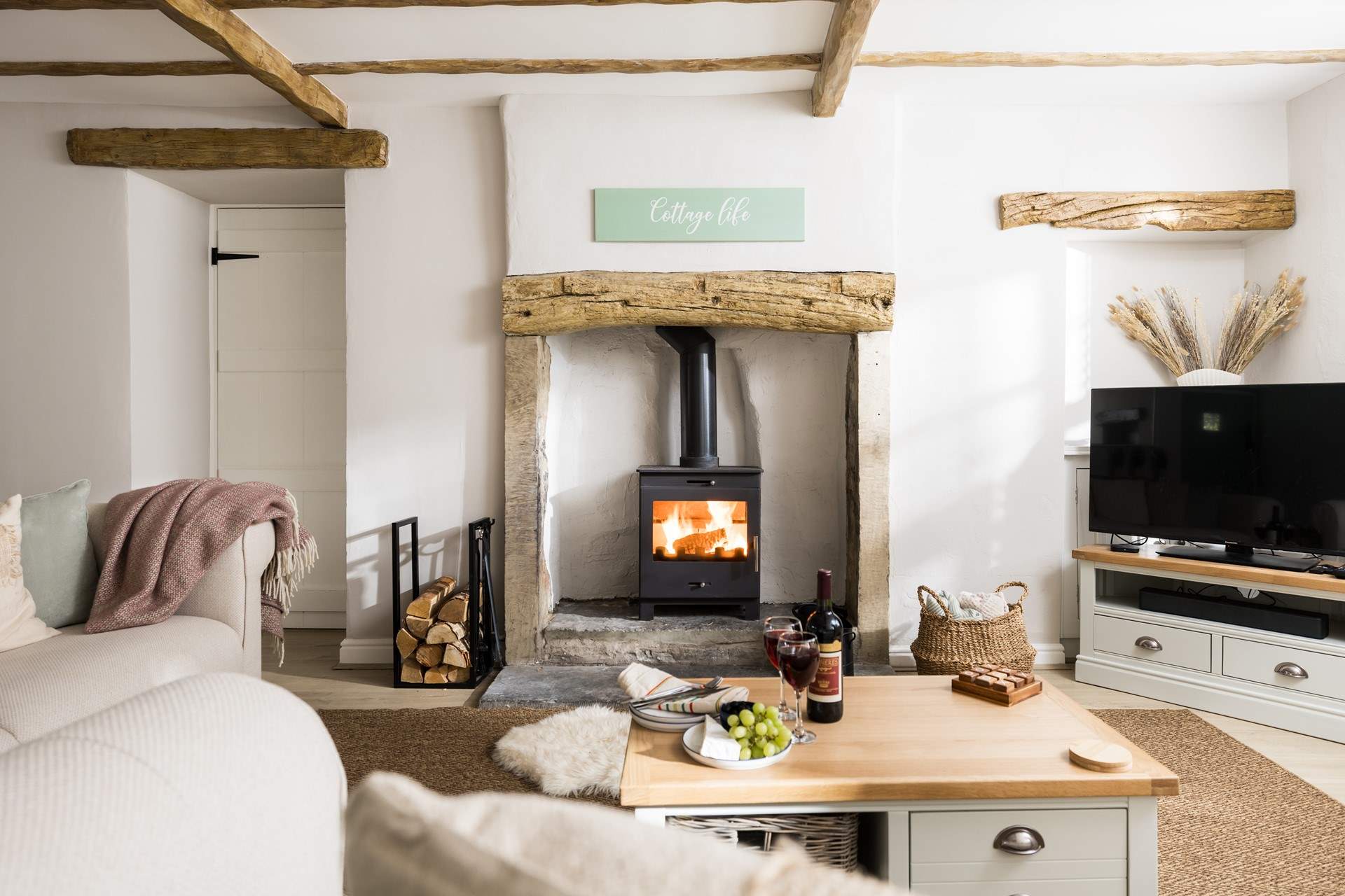 Relax in front of the wood-burner in this beautifully furnished sitting-room.