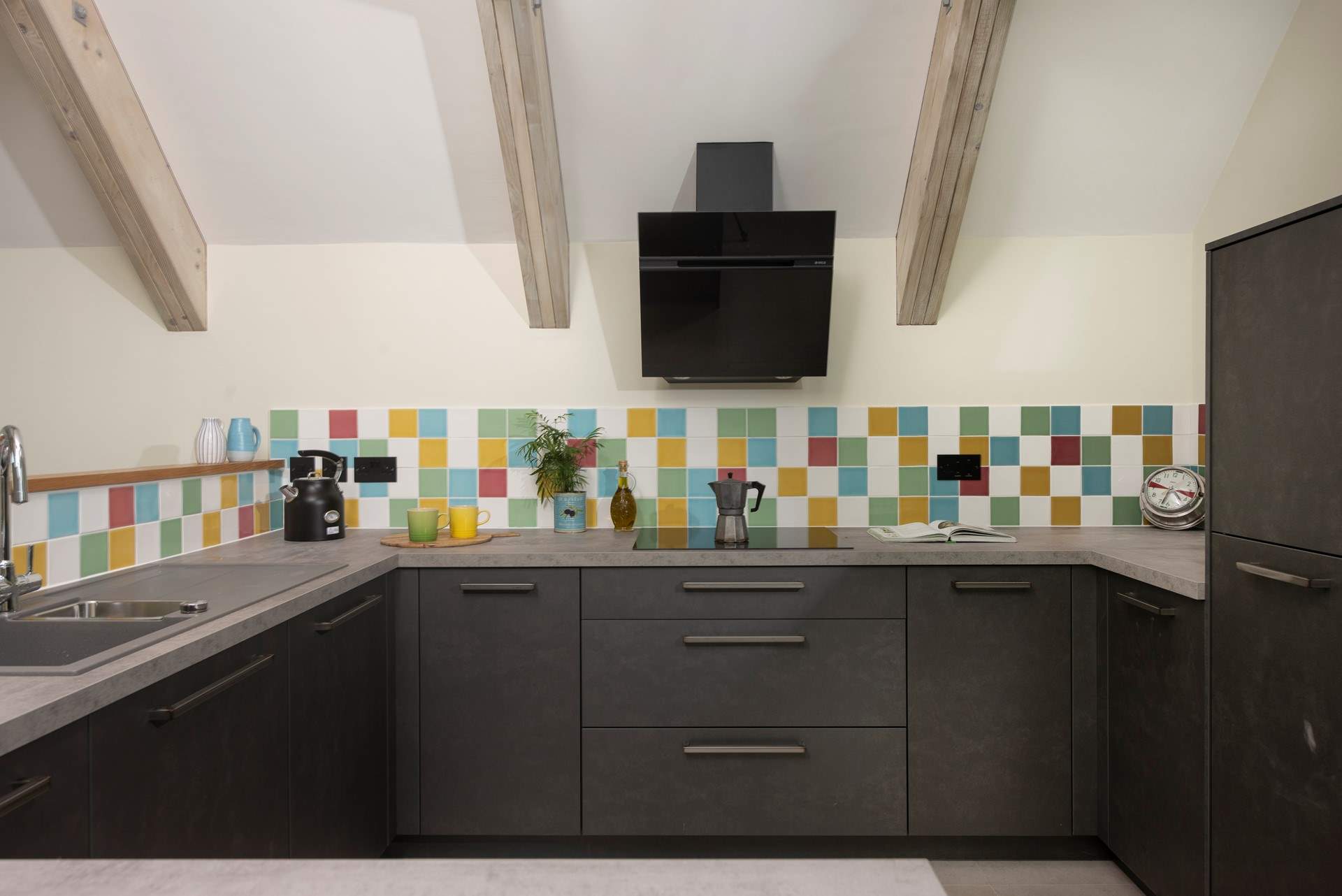 The kitchen overlooks the living area and is open airy and social.