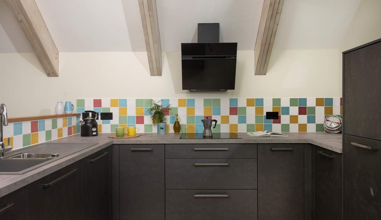 The kitchen overlooks the living area and is open airy and social.