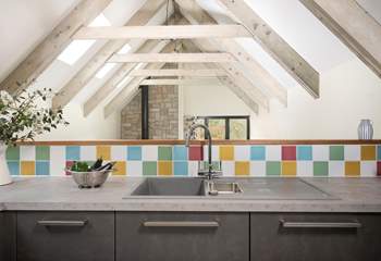 The kitchen is sleek and modern and the beamed ceilings are just stunning. 