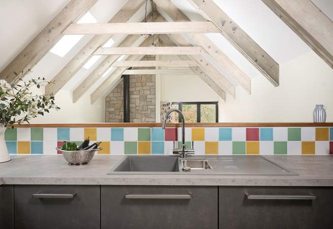 The kitchen is sleek and modern and the beamed ceilings are just stunning. 