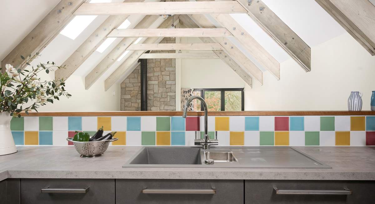 The kitchen is sleek and modern and the beamed ceilings are just stunning. 