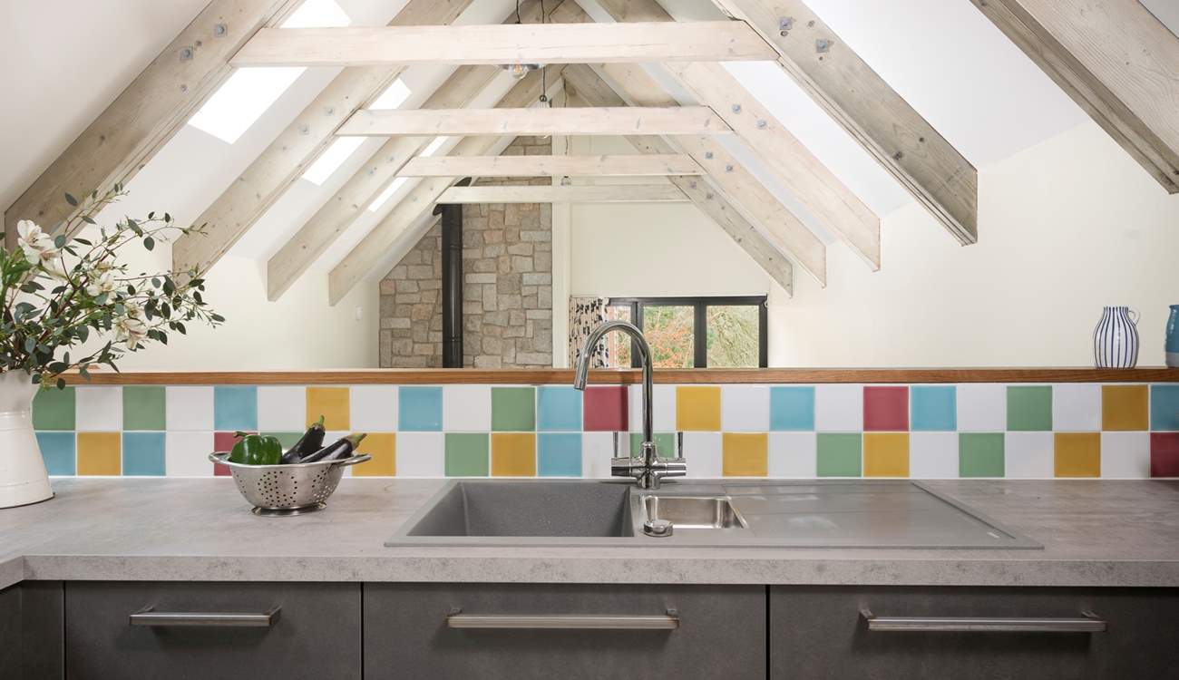 The kitchen is sleek and modern and the beamed ceilings are just stunning. 