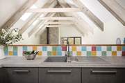 The kitchen is sleek and modern and the beamed ceilings are just stunning.
