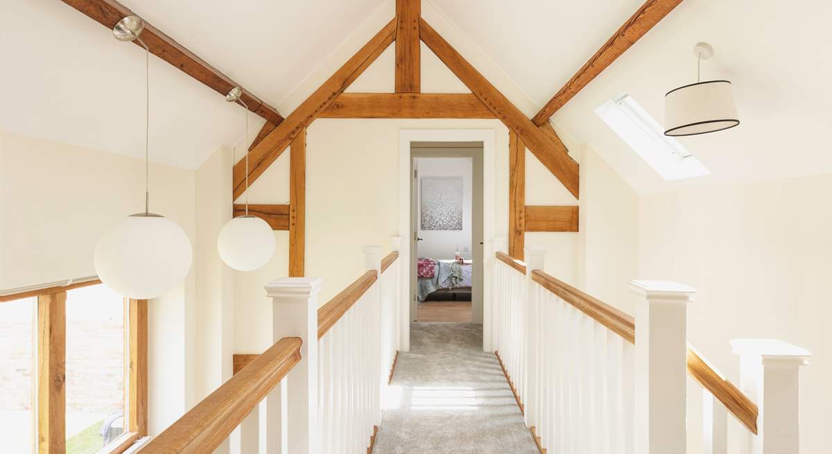 There is a feature walkway upstairs which leads to two luxurious double bedrooms.