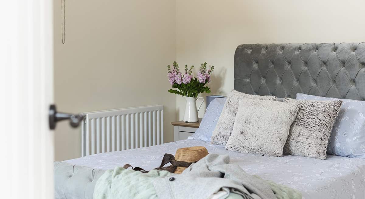 Pretty bed linen suits this cottage perfectly.