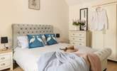 Quirky cushions adorn the bed in this cosy en suite double bedroom.   - Thumbnail Image