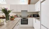 Whip up a feast in the sleek kitchen. - Thumbnail Image