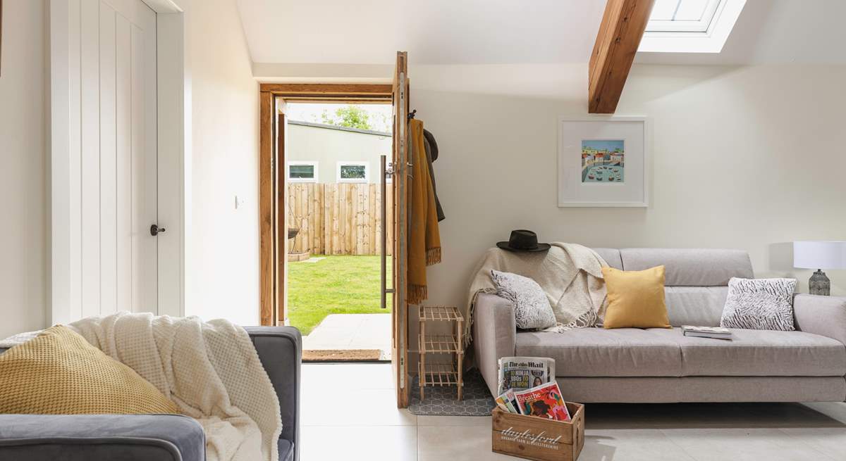 The living-room leads out onto the large lawned garden.