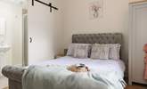 A second en suite bedroom has stylish barn doors, just the thing for a converted farm building. - Thumbnail Image