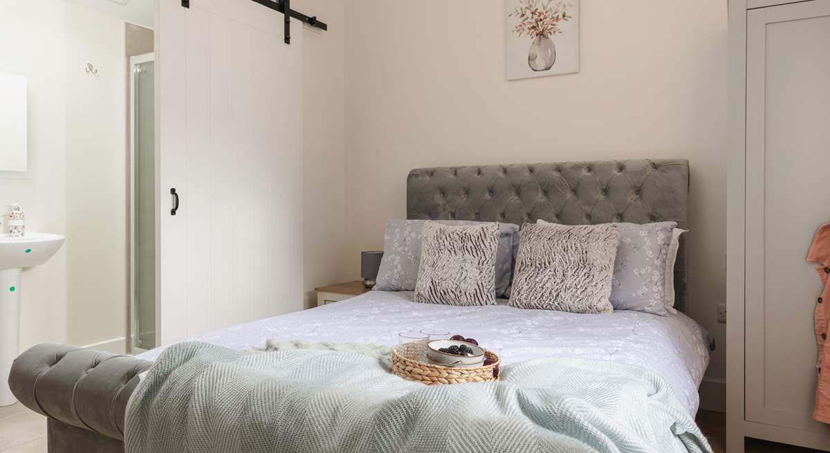 A second en suite bedroom has stylish barn doors, just the thing for a converted farm building.