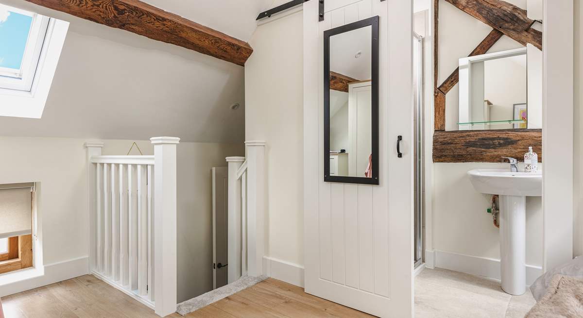 Sleek barn doors lead into the en suite shower-room. 