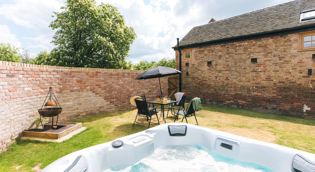 The lovely private garden complete with hot tub and fire-pit. 