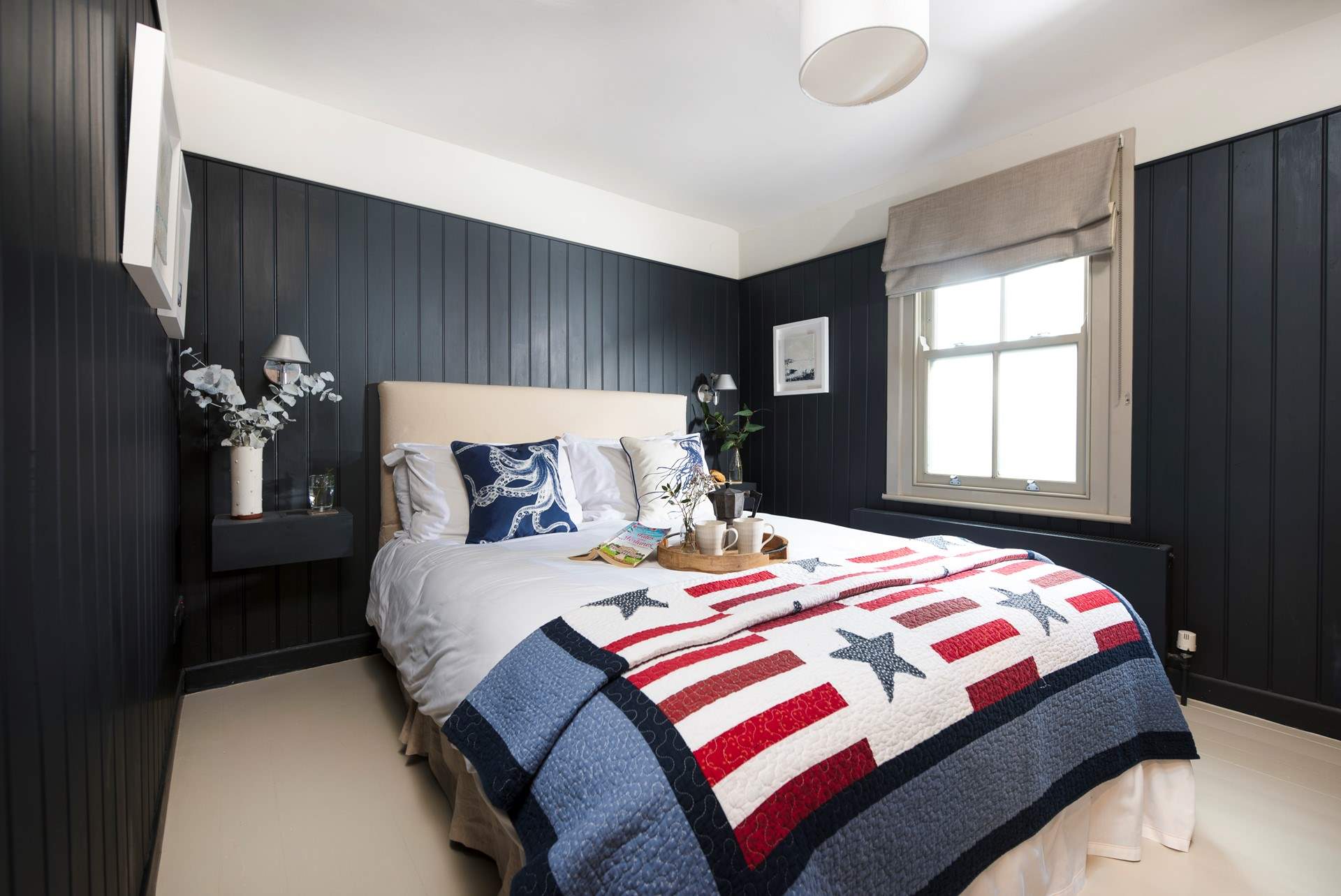 The stylish bedroom with wooden flooring.