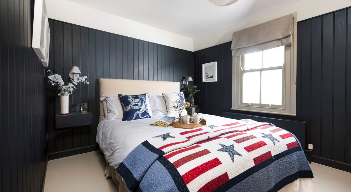 The stylish bedroom with wooden flooring.