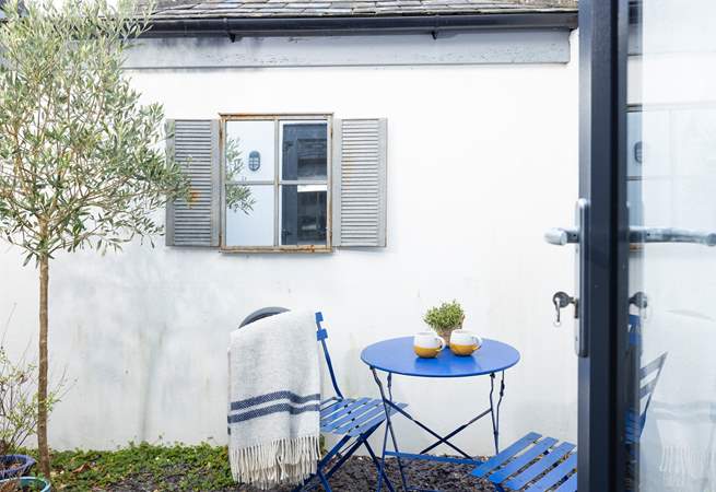 Guests in bedroom one can enjoy a peaceful morning coffee outside. 