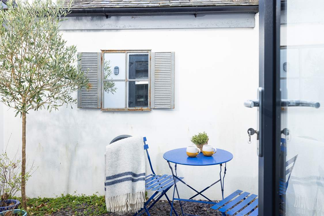 Guests in bedroom one can enjoy a peaceful morning coffee outside.