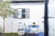 Guests in bedroom one can enjoy a peaceful morning coffee outside.